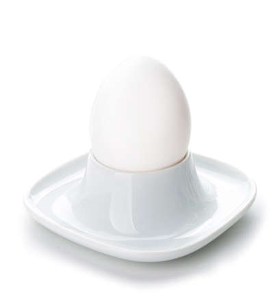 Holder with fresh raw egg on white backgroundの写真素材