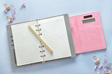 Stylish notebook with calculator and stationery on white table