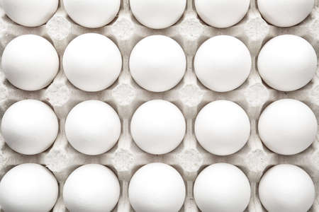 Many fresh raw eggs in box, top view