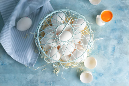 Basket with fresh raw eggs on table