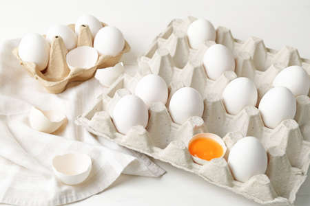 Box with fresh raw eggs on table