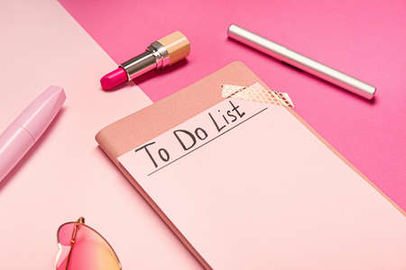 Empty to do list with makeup cosmetics on color backgroundの写真素材
