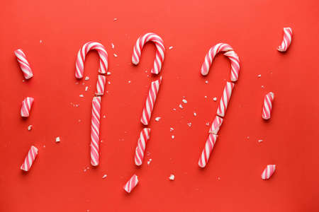 Broken candy canes on color backgroundの写真素材