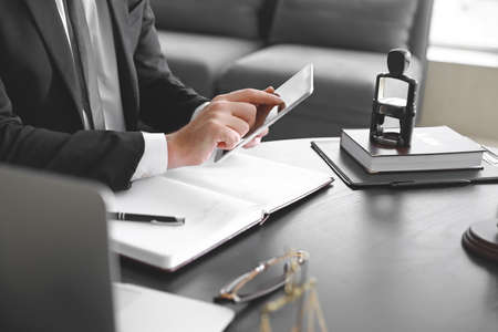Male lawyer sitting at workplace in office