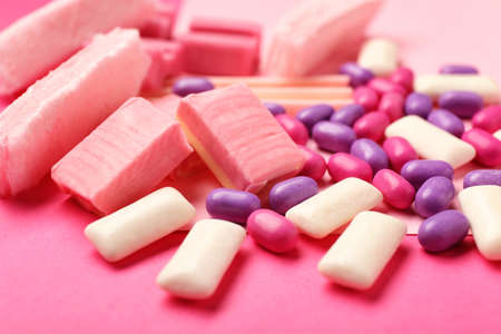 Different chewing gums on color background