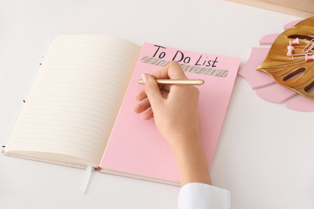 Woman making to do list at table