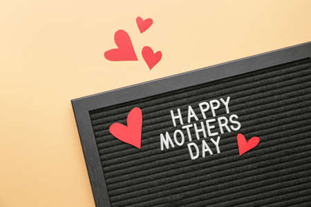 Board with text HAPPY MOTHER'S DAY on color backgroundの写真素材