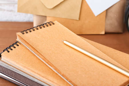 Notebooks with pen on table, closeup