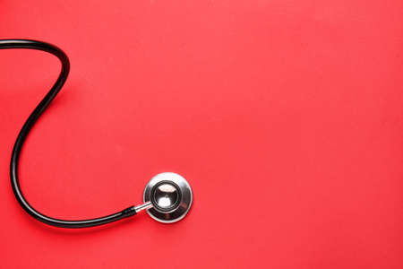Modern stethoscope on color backgroundの写真素材