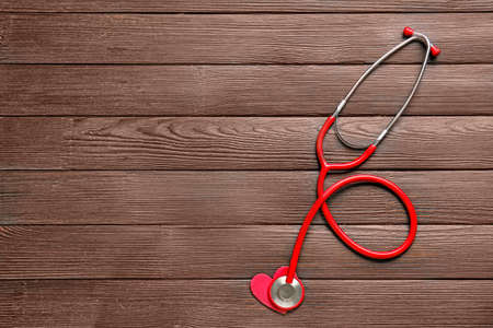 Stethoscope and heart on wooden backgroundの写真素材