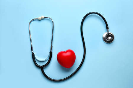 Stethoscope and heart on color backgroundの写真素材