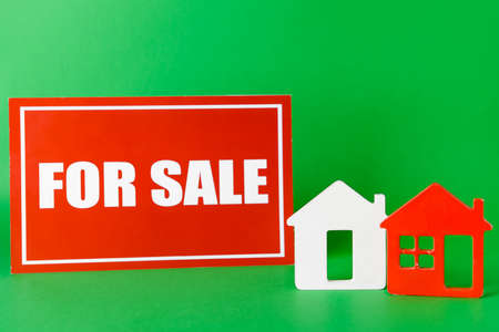 Figures of houses with text FOR SALE on color background