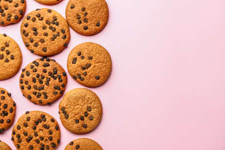 Tasty cookies with chocolate chips on color backgroundの写真素材