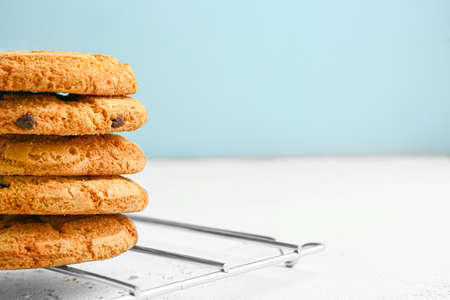 Tasty cookies with chocolate chips on table