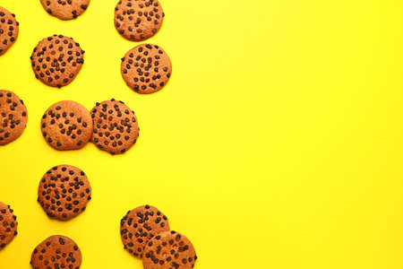 Tasty cookies with chocolate chips on color backgroundの写真素材