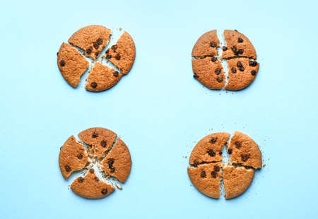 Tasty crushed cookies with chocolate chips on color backgroundの写真素材