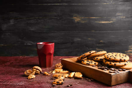 Tasty cookies with chocolate chips on table