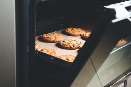 Baking tray with tasty cookies in ovenの写真素材