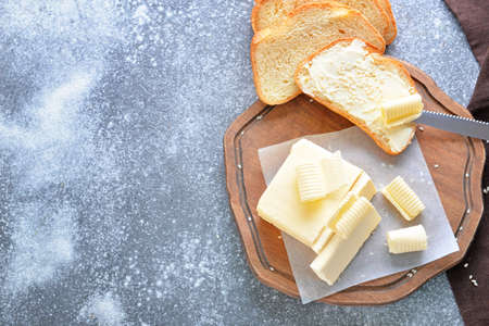 Fresh butter with bread on gray backgroundの写真素材