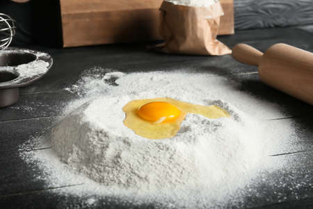 Flour with egg on dark tableの写真素材