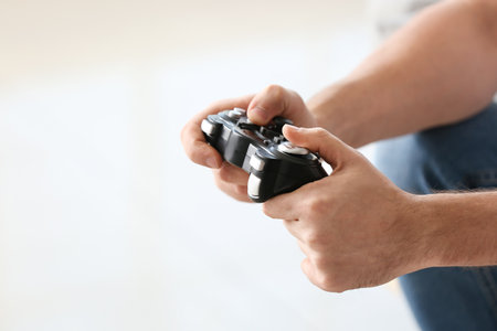 Man playing video games at home, closeup