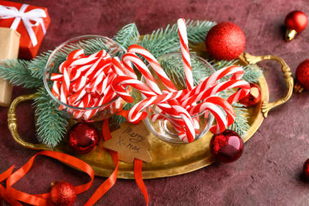 Composition with Christmas candy canes on tableの写真素材