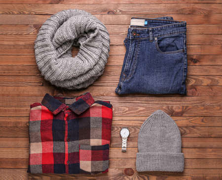 Set of winter clothes on wooden backgroundの写真素材