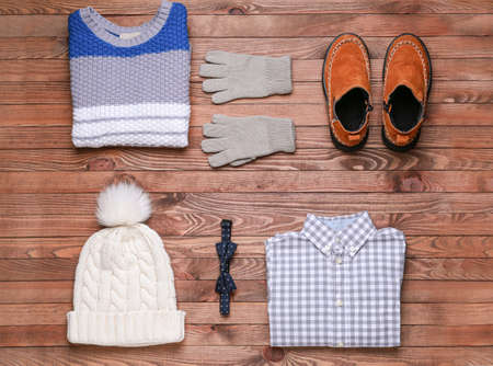 Set of winter clothes on wooden backgroundの写真素材