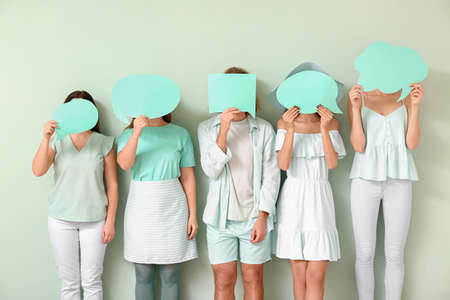 People with blank speech bubbles on color background