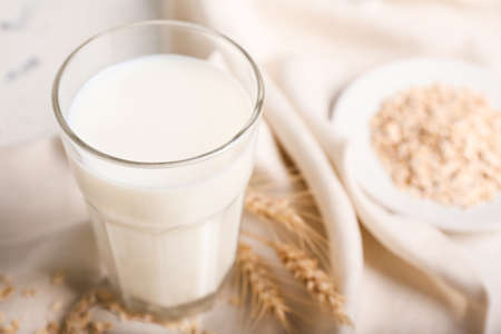 Glass of tasty oat milk on tableの写真素材