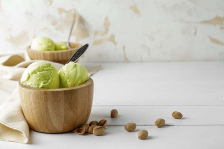 Bowl with tasty ice-cream on table