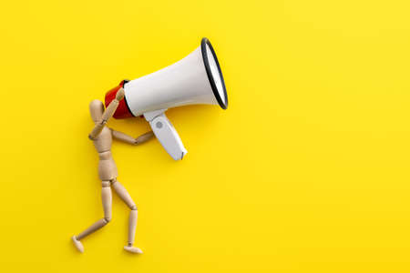 Megaphone with mannequin on color background