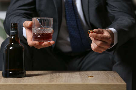 Divorced man drinking cognac at home. Concept of alcoholism