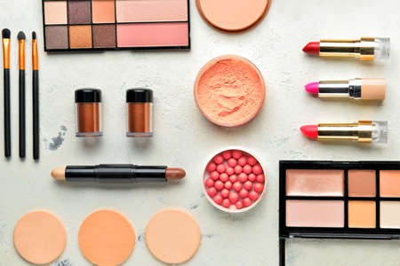 Set of decorative cosmetics and accessories on light background