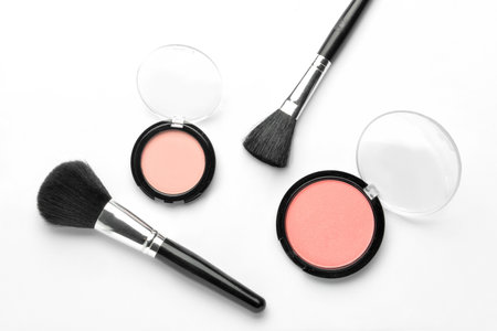 Makeup brushes and cosmetics on white backgroundの写真素材