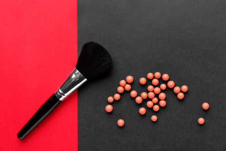 Makeup brush and rouge balls on color backgroundの写真素材