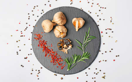 Composition with black garlic on white backgroundの写真素材