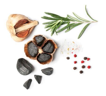 Black garlic, herbs and spices on white backgroundの写真素材