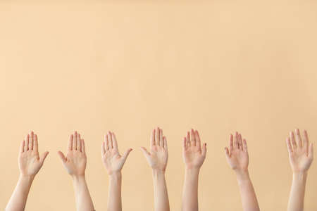 Hands of voting people on color backgroundの写真素材