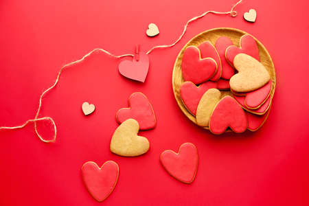 Plate with heart shaped cookies for Valentine's day on color backgroundの写真素材