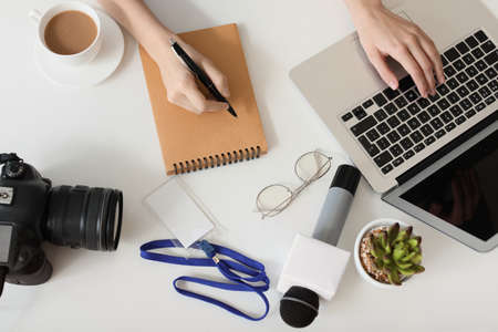 Female journalist working in officeの写真素材