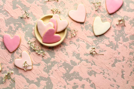 Composition with heart shaped cookies for Valentine's day on color background