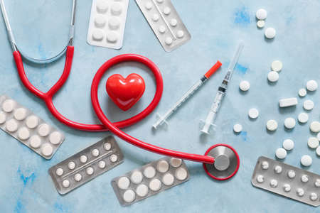 Stethoscope, heart and pills on light background. Cardiology conceptの写真素材