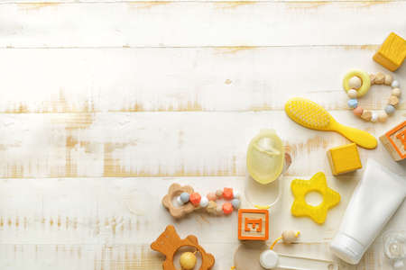 Baby accessories on white wooden background
