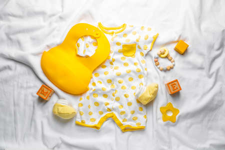Baby clothes and accessories on blanketの写真素材