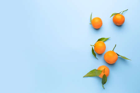 Sweet tangerines on color background