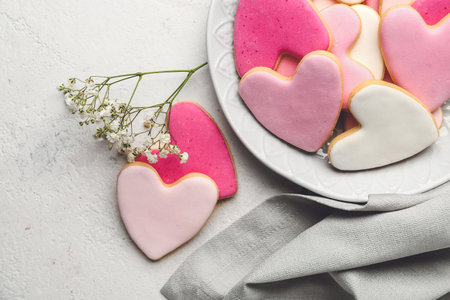 Plate with tasty heart-shaped cookies on white background. Valentines Day celebration