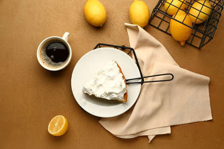 Plate with piece of tasty lemon pie and coffee on tableの写真素材