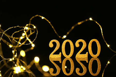Figure 2020 and Christmas lights on dark backgroundの写真素材