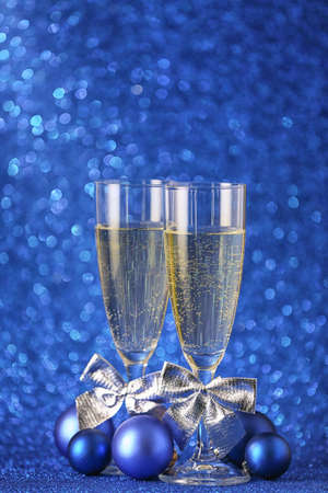 Glasses of champagne and Christmas decor on color backgroundの写真素材